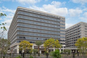 A modern hotel with multiple floors, large windows, and a prominent entrance with a covered area. - Ji Hotel Guangzhou Baiyun Airport Terminal 2 (Guangzhou)