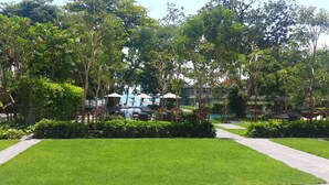 A lush garden with a pool, outdoor seating, and a clear view of the surrounding buildings.