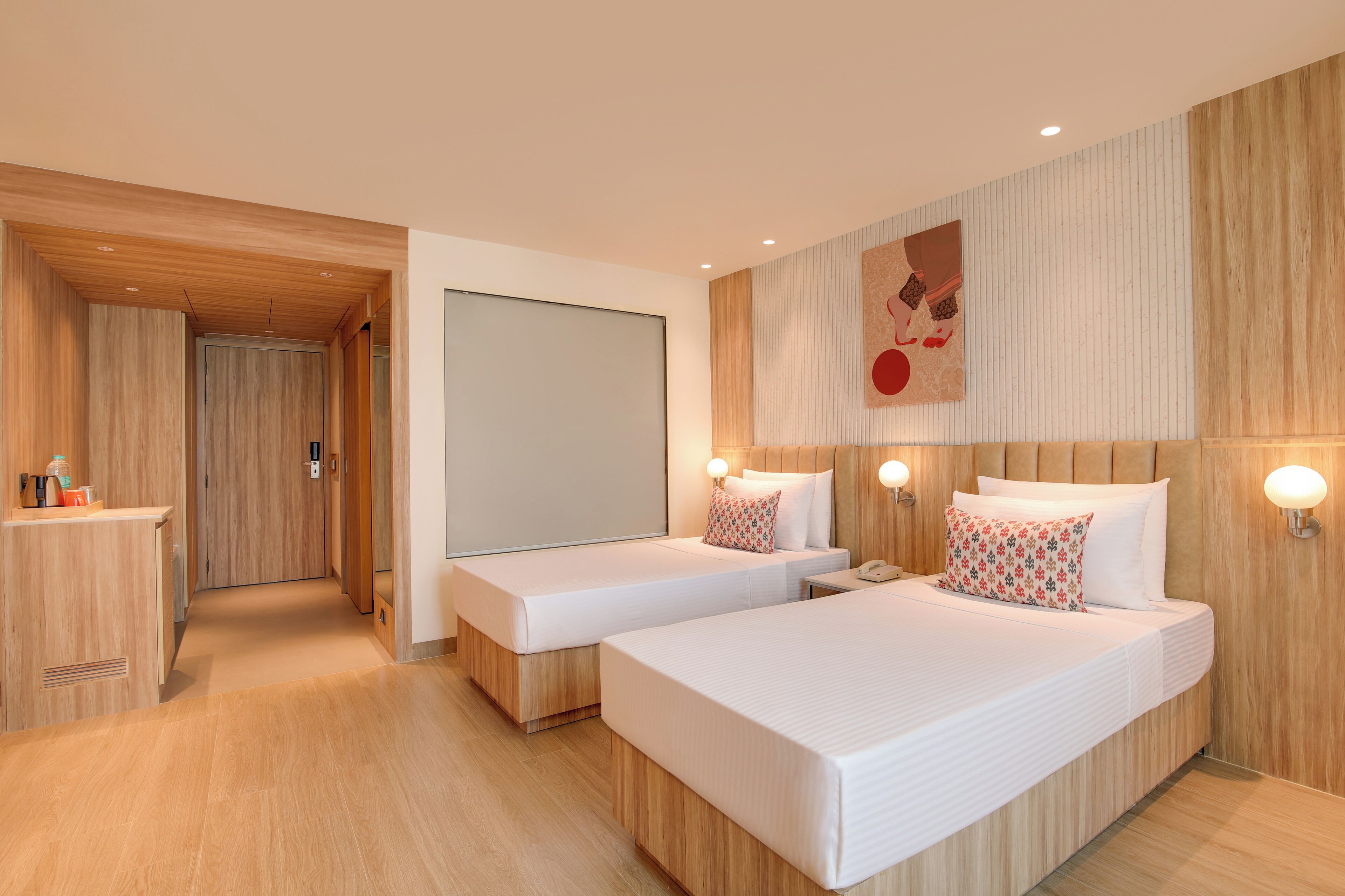 A modern hotel room with two beds, wooden paneling, a large mirror, and a wall-mounted artwork.