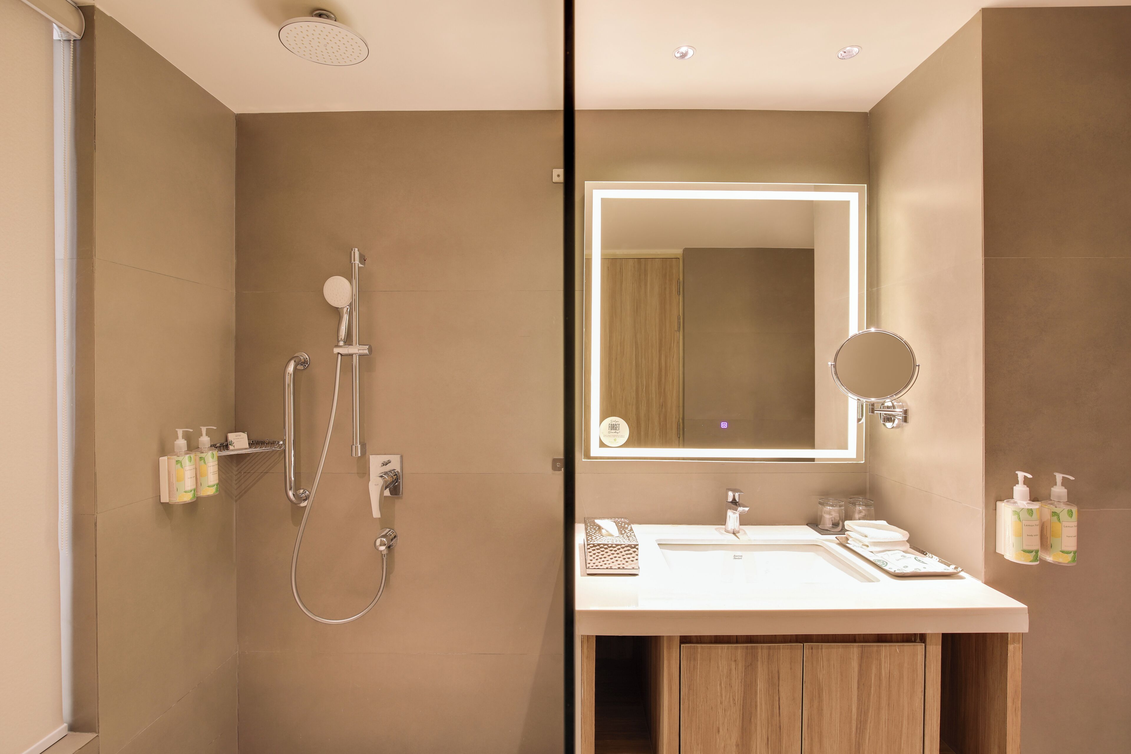 A modern bathroom with a shower, sink, and mirror.