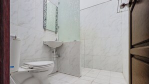 A bathroom with a toilet, sink, and mirror. - OYO 94780 Blessing Homestay (Surabaya)