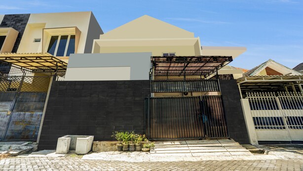 A modern house with a black gate, a white garage door, and a paved driveway. - OYO 94780 Blessing Homestay (Surabaya)