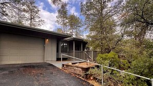 A two-story house with a covered porch and a garage. - Sagewood Cottage: A private home with comfort, style, amazing amenities, and Tranquil location! (Prescott)