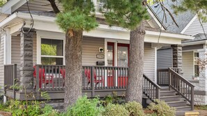 A two-story house with a front porch, a staircase, and a mailbox. - Spacious Home for Groups with Firepit & Backyard (Louisville)