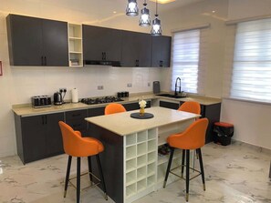 Classic Apartment, Balcony, City View | Private kitchenette | Fridge, microwave, oven, stovetop - Welead Homes  (Abuja)