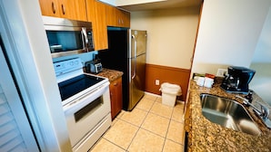 A compact kitchen with a microwave, toaster, oven, refrigerator, and a coffee maker. - Key Largo 1BR - Ocean View, Near Founders Park (Tavernier)