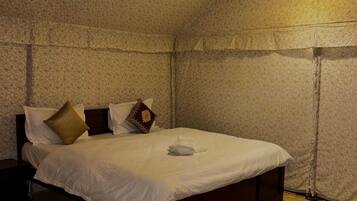 Un dormitorio con una cama individual, una lámpara colgante y una pared con textura.