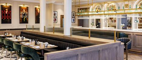A restaurant with a long counter, booths, and a bar area.