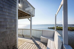 A wooden deck with a railing overlooking a body of water. - New Listing! Water Views, Sunsets and Much More! (Kill Devil Hills)
