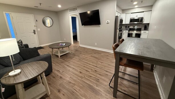 A modern apartment with a living room, dining area, and kitchen. - Central to Zoo and Baxter Arena, Pet Friendly (Omaha)