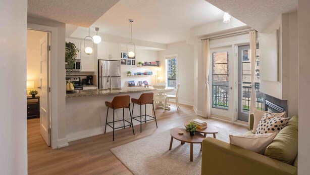 A modern apartment with a kitchen, dining area, and living room. - 13th Ave Condo + City Views + Balcony + Walkable (Calgary)