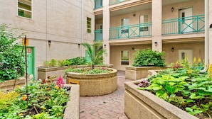 A courtyard with multiple planters and a brick pathway. - 13th Ave - DT Calgary - 2BD 2BA - Sleeps 5 (Calgary)