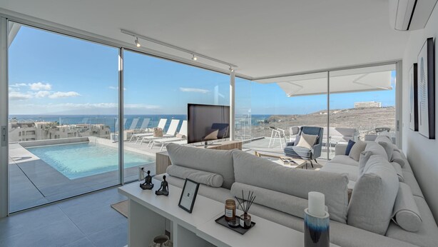 A modern living room with a large window, a pool view, and a comfortable seating area. - Casangular by Upper (Adeje)