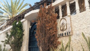 A building with a sign reading "ECO BAY" and a black gate. - Eco Bay Surf Camp (Aourir)