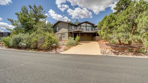 A two-story house with a covered driveway and a front yard with various plants and trees. - Walk to Park & Trails! Mtn-view Sedona Haven (Sedona)