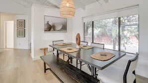 A dining area with a large table, chairs, and a hanging light fixture. - Walk to Park & Trails! Mtn-view Sedona Haven (Sedona)