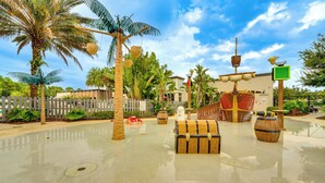 A tropical-themed area with palm trees, a wooden ship, and a treasure chest. - Fall Family Fun Near Disney! Resort Perks & Golf (Davenport)