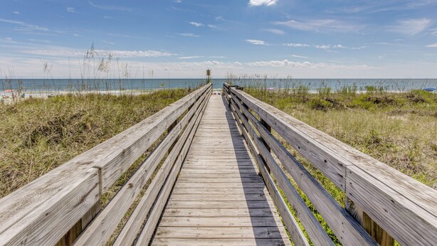 A wooden boardwalk leading to the beach. - Direct Beach Access! Walkable Condo on Ocean Blvd (North Myrtle Beach)