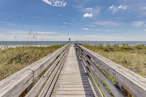 A wooden boardwalk leading to the beach.