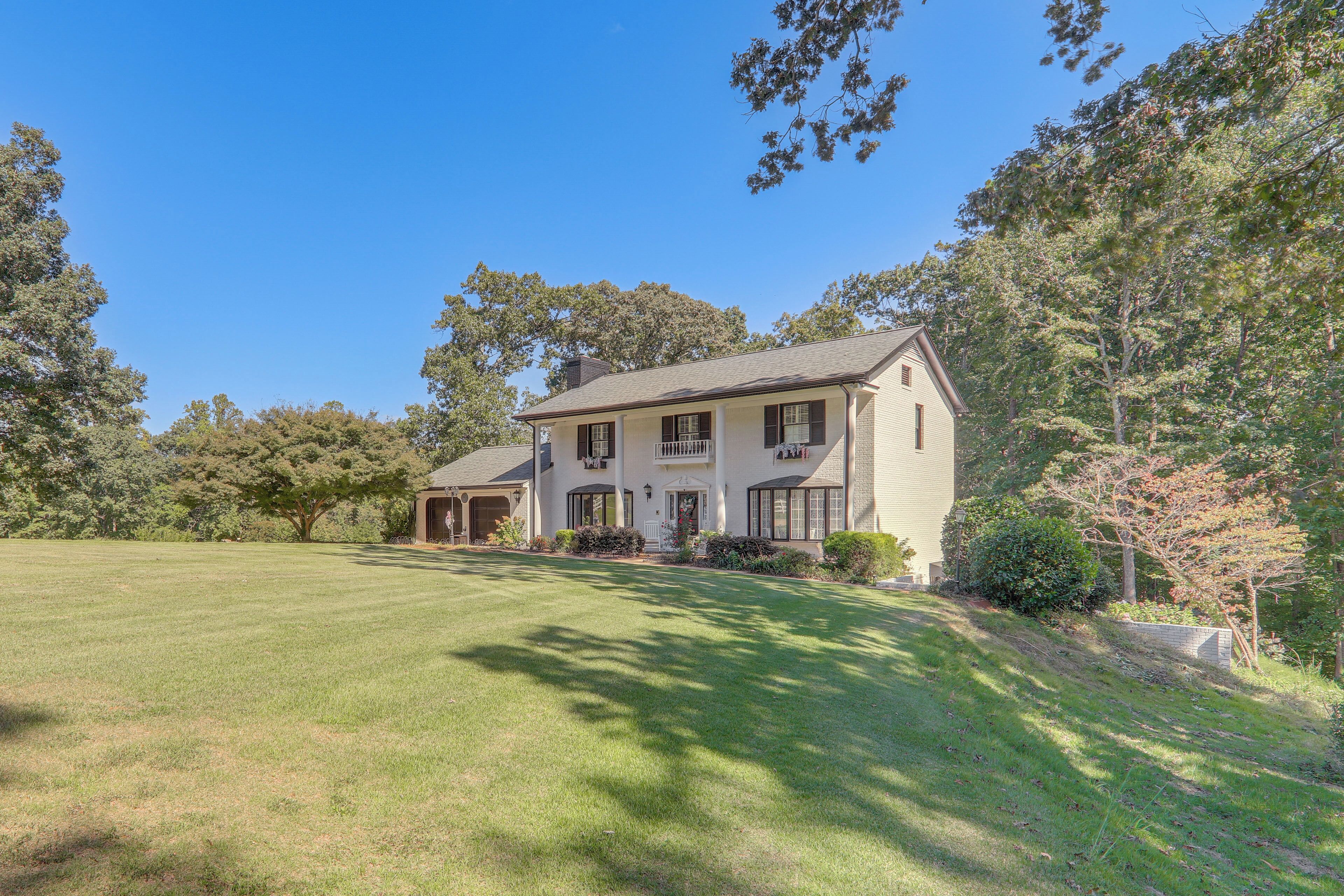 A two-story house with a front porch, a covered entryway, and a well-maintained lawn.