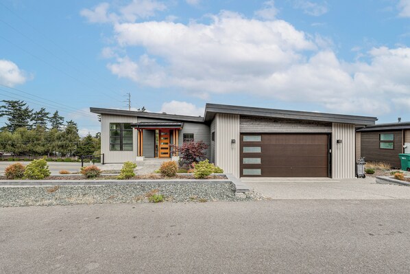 A modern two-story house with a garage, a front porch, and a landscaped front yard. - Fenced Yard, Water & Island Views: Anacortes Home! (Anacortes)