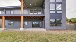A modern two-story building with a balcony, large windows, and a flat roof. - Fenced Yard, Water & Island Views: Anacortes Home! (Anacortes)