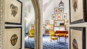 A room with framed artwork, a chandelier, and ornate furniture. - Domaine de la Boisisère (Trouville-la-Haule)