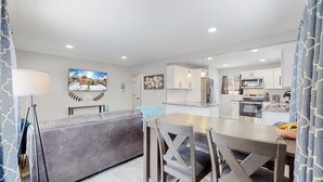 A modern kitchen with white cabinets, a built-in oven, and a microwave. - Affordable four bedroom Family Denver home (Denver)