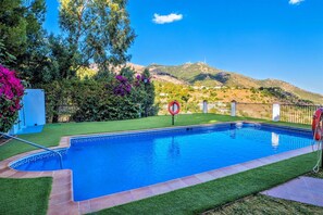 A swimming pool with a clear view of a mountain in the background.
