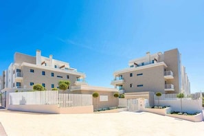 A modern building with a symmetrical facade, multiple balconies, and a gated entrance. - Luxury living with sea views. Walk to the beach (La Cala de Mijas)
