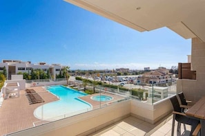 A rooftop pool with a clear view of the surrounding buildings and a parking area. - Luxury living with sea views. Walk to the beach (La Cala de Mijas)