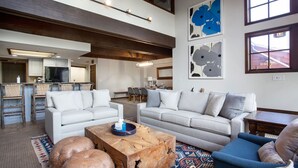A spacious living area with a high ceiling, a kitchen in the background, and a dining area. - Stag Lodge at Deer Valley Resort - Three Bedroom Residence with Spa #9 3 Condo (Park City)