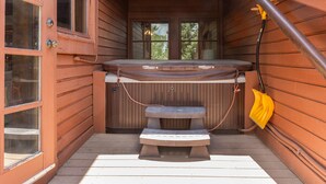 A wooden cabin with a hot tub, a bench, and a door with windows. - Stag Lodge at Deer Valley Resort - Three Bedroom Residence with Spa #9 3 Condo (Park City)