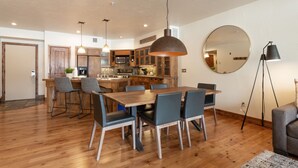 A modern kitchen with wooden cabinets, a central island, and pendant lighting. - The Lodges at Deer Valley 1 Bedroom Condo (Park City)