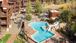 A resort with a central pool, outdoor seating, and a waterfall feature. - Silver Baron Lodge 2 Condo Bedroom with Spa by Deer Valley Resort (Park City)