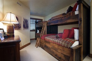A bunk bed with a ladder, a bedside table with a lamp, and framed pictures on the wall. - Grand Lodge - 3 Bedroom Condo Deluxe #308 - Ski-in/out by Deer Valley Resort (Park City)