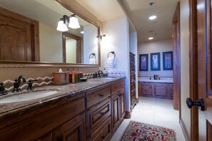 A bathroom with wooden cabinetry, a large mirror, and a sink with a towel rack. - Grand Lodge - 3 Bedroom Condo Deluxe #308 - Ski-in/out by Deer Valley Resort (Park City)