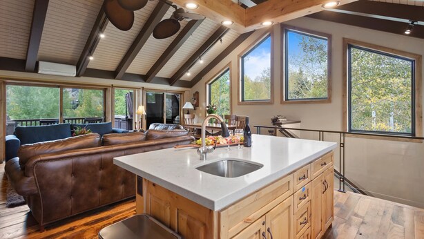 A spacious kitchen with a large island, wooden cabinets, and a view of the outdoors. - Queen Esther at Deer Valley Resort - Two Bedroom Condo with Hot Tub #2346 2 Condo (Park City)