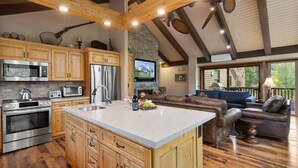 A spacious kitchen with wooden cabinets, stainless steel appliances, and a large island. - Queen Esther at Deer Valley Resort - Two Bedroom Condo with Hot Tub #2346 2 Condo (Park City)