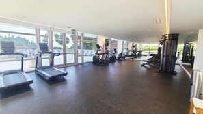 A gym with treadmills, elliptical machines, and weight equipment. - NEW Amrit Resort Oceanview Retreat (Singer Island)