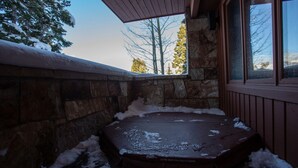 A stone-walled hot tub area with a wooden bench and a window overlooking trees. - Ridge at Deer Valley Resort - Three Bedroom Condo with Hot Tub #16 3 Condo (Park City)