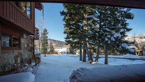 A stone building with a wooden balcony, surrounded by snow-covered trees and a clear sky. - Ridge at Deer Valley Resort - Three Bedroom Condo with Hot Tub #16 3 Condo (Park City)