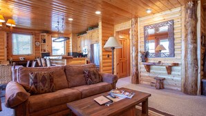 A cozy cabin interior with a wooden ceiling, a sofa, a coffee table, and a dining area. - Comstock Lodge at Deer Valley Resort - Two Bedroom Condo with Hot Tub #101 2 Condo (Park City)