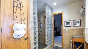A bathroom with a wooden door, a glass shower enclosure, and a tiled floor. - Pinnacle at Deer Valley Resort - Four Bedroom Condo with Hot Tub #1065 4 Condo (Park City)