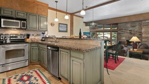 A kitchen with granite countertops, stainless steel appliances, and a large island. - Powder Run at Deer Valley Resort - Two Bedroom Condo with Hot Tub #A13 2 Condo (Park City)