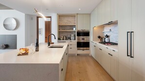 A modern kitchen with a central island, built-in oven, and stainless steel appliances. - Argent at Deer Valley Resort - Three Bedroom Deluxe #405 3 Condo (Park City)