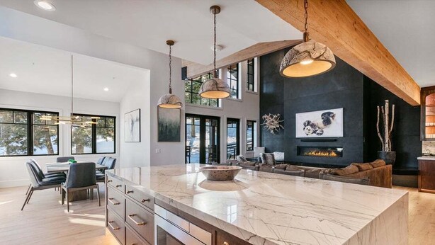 A modern kitchen with a large marble island, wooden cabinets, and pendant lighting. - Stag Lodge at Deer Valley Resort - Four Bedroom with Spa #30 4 Condo (Park City)