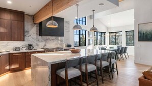 A spacious kitchen with marble countertops, wooden cabinets, and pendant lighting. - Stag Lodge at Deer Valley Resort - Four Bedroom with Spa #30 4 Condo (Park City)