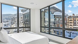 A bedroom with a large window offering a view of a snowy mountain resort. - Argent at Deer Valley Resort - Two Bedroom Deluxe #401 2 Condo (Park City)