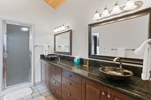 A bathroom with a double sink, vanity, and a large mirror. - 2430 Queen Esther Dr - 5 Bedroom Home with Spa by Deer Valley Resort (Park City)